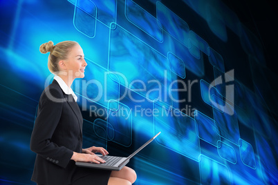 Composite image of businesswoman using laptop