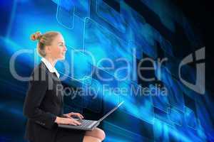 Composite image of businesswoman using laptop