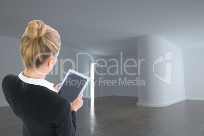 Composite image of businesswoman holding new tablet