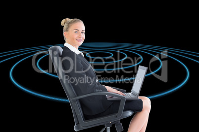 Composite image of businesswoman sitting on swivel chair with la