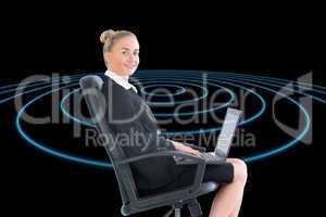 Composite image of businesswoman sitting on swivel chair with la