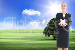 Composite image of businesswoman holding pink piggy bank