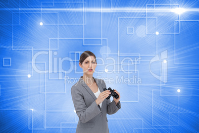 Composite image of curious young businesswoman posing with binoc