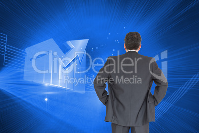 Composite image of businessman standing back to the camera with