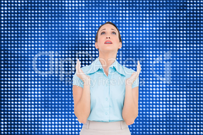 Composite image of concerned young businesswoman praying