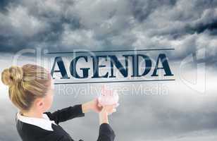 Composite image of businesswoman holding pink piggy bank