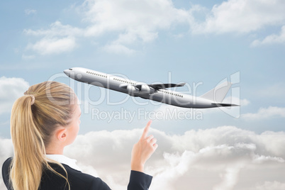 Composite image of businesswoman pointing somewhere