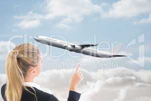 Composite image of businesswoman pointing somewhere