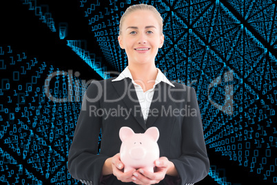 Composite image of businesswoman holding piggy bank