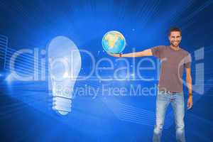 Composite image of handsome man holding out a globe