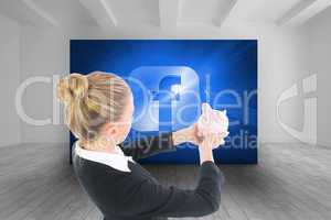 Composite image of businesswoman holding piggy bank