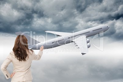 Composite image of businesswoman standing back to camera writing