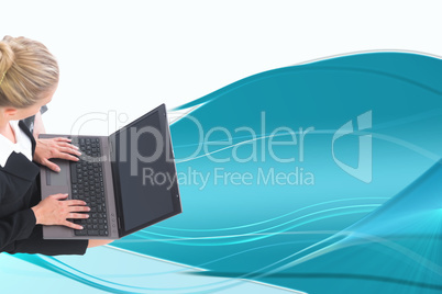 Composite image of businesswoman using laptop