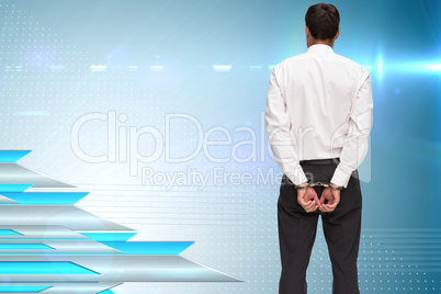 Composite image of rear view of young businessman wearing handcu