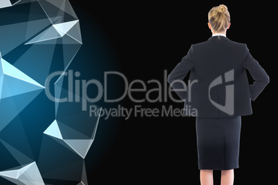 Composite image of businesswoman standing with hands on hips