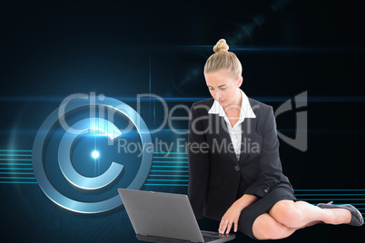 Composite image of businesswoman using laptop