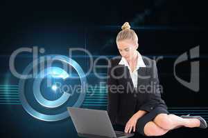 Composite image of businesswoman using laptop