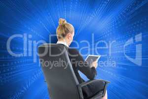 Composite image of businesswoman sitting on swivel chair with ta