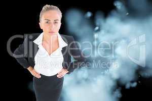 Composite image of businesswoman standing with hands on hips