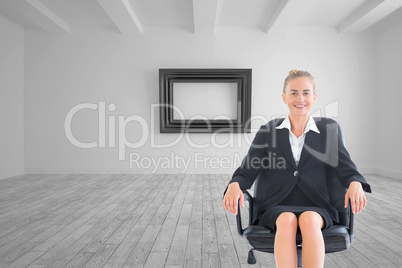 Composite image of businesswoman sitting on swivel chair in blac