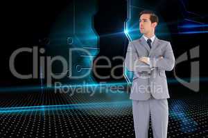 Composite image of serious businessman with arms crossed