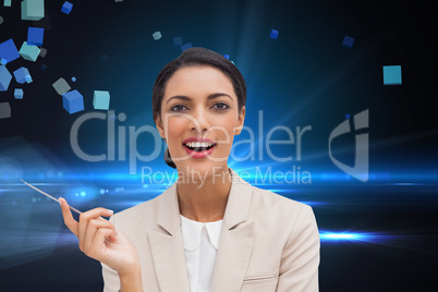 Composite image of smiling businesswoman holding a pen