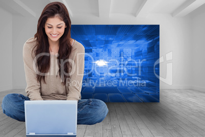 Composite image of brunette sitting on floor using laptop