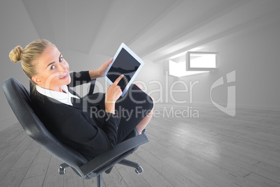 Composite image of businesswoman sitting on swivel chair with ta