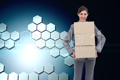 Composite image of smiling businesswoman carrying cardboard boxe