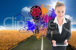 Composite image of businesswoman holding new tablet