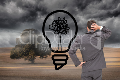 Composite image of young businessman standing back to camera scr