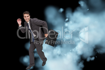 Composite image of happy businessman in a hury