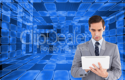 Composite image of businessman holding a tablet computer