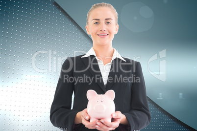 Composite image of businesswoman holding piggy bank