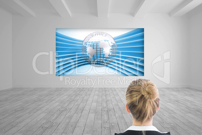 Composite image of businesswoman standing with hands on hips