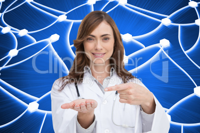 Composite image of smiling doctor presenting her hand