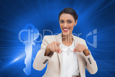 Composite image of smiling businesswoman pointing at the camera