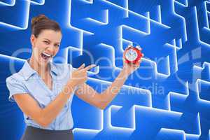 Composite image of businesswoman indicating alarm clock