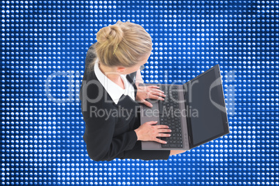 Composite image of businesswoman using laptop