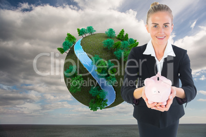 Composite image of businesswoman holding pink piggy bank