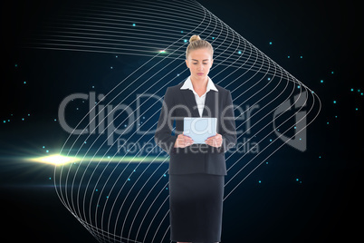 Composite image of businesswoman holding new tablet