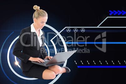 Composite image of businesswoman using laptop