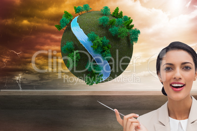 Composite image of smiling businesswoman holding a pen