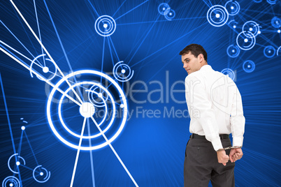 Composite image of businessman wearing handcuffs