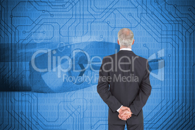 Composite image of rear view of serious businessman posing