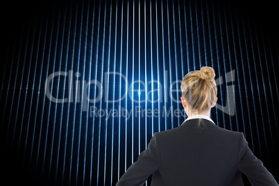 Composite image of businesswoman standing with hands on hips Composite image of businesswoman standing with hands on hips