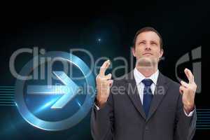Composite image of serious businessman with fingers crossed is l