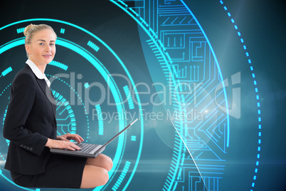 Composite image of businesswoman using laptop