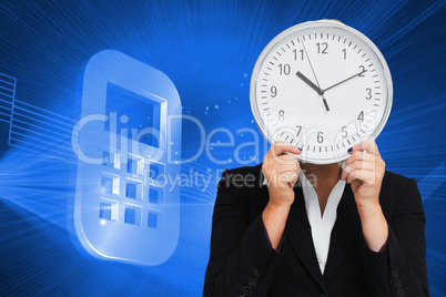 Composite image of businesswoman in suit holding a clock