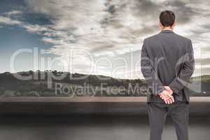 Composite image of rear view of classy businessman posing